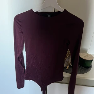 Vinröd långärmad bodysuit från newyorker  - Vinröd långärmad bodysuit från newyorker. Tillverkad i ett stretchigt, slätt material som sitter tight mot kroppen. Perfekt att ha till allt. Använd 1 gång 