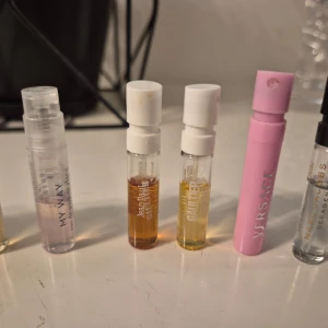Parfymprover från olika märken - Säljer ett set med parfymprover från flera kända märken som Versace, Jean Paul Gaultier, Escada och Ariana Grande. Proverna kommer i små glasflaskor med spray eller skruvkork, vissa med färgad vätska och andra genomskinliga. Perfekt för dig som vill testa nya dofter. Karl lagerfeld  Hugo boss Alive VR good fortune Escada celebrate Escada celebrate life Ariana grande moonlight Armani My way Jean paul  Jean paul gaulter divine Versace bright crystal  Marc jacobs decadence
