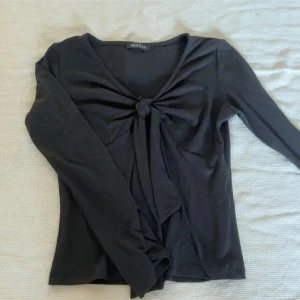 Svart långärmad topp med knyt från Missay - - Svart blus från Missay - Storlek M/L på lappen men sitter som XS/S - Näst intill nyskick  - Inga defekter  Skriv om ytligare funderingar tryck annars köp nu 