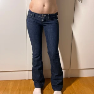 Lågmidjade bootcut jeans lee super lågmidjade utsvängda jeans  - SuperLågmidjade från Lee. W26L33. Superfint skick. Innerbenslängd:80 midjemått:37. Köp sker via köp nu, jag postar inom 24h. Kvar tills markerad såld 