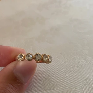 Guldfärgad ring med stora stenar - Säljer en guldfärgad ring med sex klara stenar i rad. Ringen har en klassisk och elegant design. Aldrig använd, säljer eftersom den är för liten för mig, pris kan diskuteras ❤️❤️