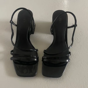 Svarta klackskor från Zara - Storleken är 35 men passar även 36. Använd 2 gånger. Snygga svarta klackskor från Zara med en elegant design. Skorna har en fyrkantig tå och remmar som ger en stilren look. Perfekta för en kväll ute eller en speciell tillställning.