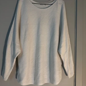 Vit ribbad långärmad tröja - Säljer en vit långärmad tröja med ribbad struktur och rund hals. Tröjan har en loose passform och är perfekt för dig som gillar en enkel och clean stil. 🥰🫶🏻
