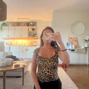 Leopardmönstrad croppad topp - Säljer en croppad topp med leopardmönster och korta ärmar. Toppen har en snygg, något v-ringad urringning och sitter tight. 