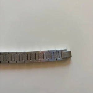 Lacoste armband - Snyggt armband i silverfärgat stål med rektangulära länkar och diskret rutmönster på varje länk från Lacoste. Stilren och modern design som passar perfekt till din vardagsstil. Länkarna ger en cool och industriell känsla. Skriv privat för mer bilder eller prisförslag!