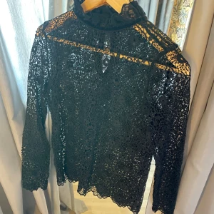 Spetsblus  - Spetsblus med krage. En knapp har ramlat av i bak men inget som märks. Storlek Xs