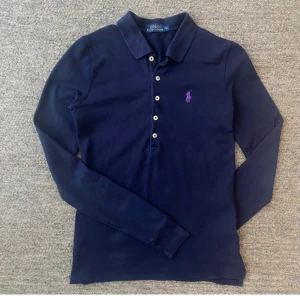 Marinblå pikétröja från Ralph Lauren - Marinblå långärmad pikétröja från Polo Ralph Lauren i bomull. Jättefint skick, stl xs.
