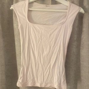 ljusrosa topp - Supersöt ljusrosa topp från Gina Tricot med fyrkantig ringning och ärmlös design. Enkel och clean look som passar perfekt till jeans eller kjol. Tunt och mjukt material som känns skönt mot huden.