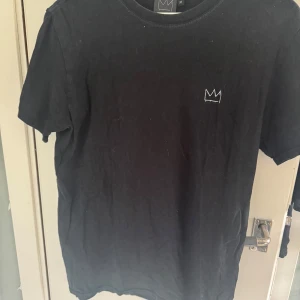 Svart Hov1 T-shirt  - Super fin svart hov1 T-shirt säljer pågrund av att den tyvärr inte kommer till användning längre, den är använd ganska så flitigt men fortfarande i ett bra skick!