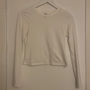 Vit långärmad basictröja - vit långärmad tröja från H&M💖Använd fåtal gånger💘Storleken är S och tröjan är lite kort i modellen, så passar nog även på någon med XS💕Säljer då den inte längre passar eller används💗Betalning sker via Swish, köparen står för frakten🩷