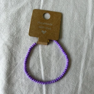 Lila pärlarmband med guldfärgat lås - Handgjort armband med små lila pärlor och ett guldfärgat klolås. Perfekt accessoar för att addera färg till din outfit. Enkel och stilren design som passar till många tillfällen.💕🫶🏼