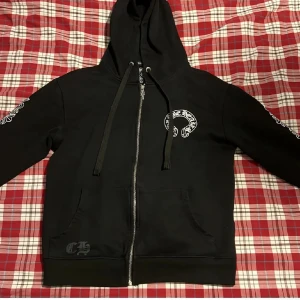 Svart Chrome Hearts hoodie med tryck bästa kvaliteten sitter skit bra den e slim och ser skit ba ut den sitter bra på s och m  - Perfekt för streetwear style och den sitter slim passar s och M men bäst S men jätte bra kvalitet och de ba o skriva om du vill ha mer bilder jag skickar den sekunden du köper den 