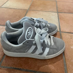 Grå Adidas Campus - Säljer fina Adidas Campus skor i grått. Säljer pg av att jag inte använder de. Bra skick, har inte använts så mycket. Storlek 39 och en tredje del. Nypris cirka 1500kr. Hör av för frågor!💓💓(pris kan diskuteras)