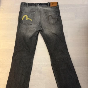 Evisu - grå jeans bootcut 33 -  jeans i bootcut-modell. Jeansen har en snygg tvättad look. Tillverkade i slitstarkt jeanstyg och passar dig som gillar en avslappnad stil.