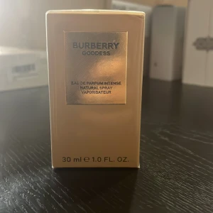 Burberry Goddess Intense 30ml - Burberry Goddess Intense är en lyxig parfym för kvinnor med tydliga toner av vanilj, lavendel och patchouli. Flaskan är elegant i guld och glas med en exklusiv känsla. Doften är varm, kryddig och träig med inslag av aromatiska och balsamiska noter. Helt ny och oöppnad. Hör av er vid minsta lilla fråga. 