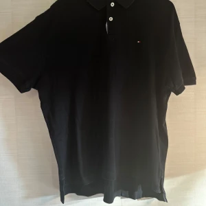 Svart pikétröja Tommy Hilfiger L - Svart Hilfiger tee med krage – enkel men clean.