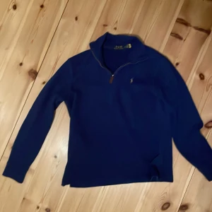 Äkta Ralph Lauren halv zip - Säljer en riktigt fin Ralph Lauren zip tröja. Denna är i jättebra skick och den är också 100% ÄKTA, man kan autentisera den via qr koden, det är bara att höra av sig vid frågor eller om man vill diskutera pris.