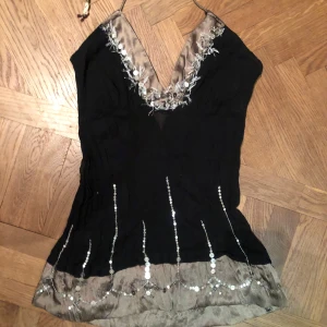 Svart och champagnefärgad paljettopp - Snygg svart VINTAGE topp!  Toppens material känns lätt och festligt, perfekt för att sticka ut med glittriga detaljer! NYSKICK! Aldrig använt❤️❤️