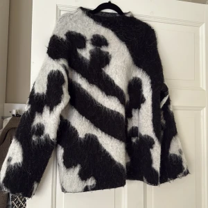 Stickad tröja mohair - Säljer en fluffig stickad tröja från STOCKH LM Studio i storlek XS. Tröjan har ett svartvitt abstrakt mönster och är tillverkad i ett mjukt, lurvigt material. Perfekt för kyligare dagar och ger en cool statement-look. Tröjan sitter oversized så passar en S med💕🌸💐🩷🤞🏽 kom gärna med prisförslag 
