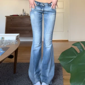 Ljusblå Only jeans - Så fina utsvängda jeans från Only! Storlek w28 L34. Innerbenslängd: 83. Midjemått: 38 + stretch. Grenhöjd: 18,5. Benvid längst ner: 23 cm. Dom är utsydda av den tidigare ägaren och ett litet hål vid sömmen.🩵🩵🩵