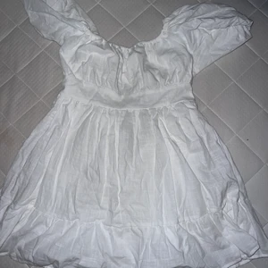 Klänning  - En vit kort klänning. Aldrig använd! Liten i storleken 