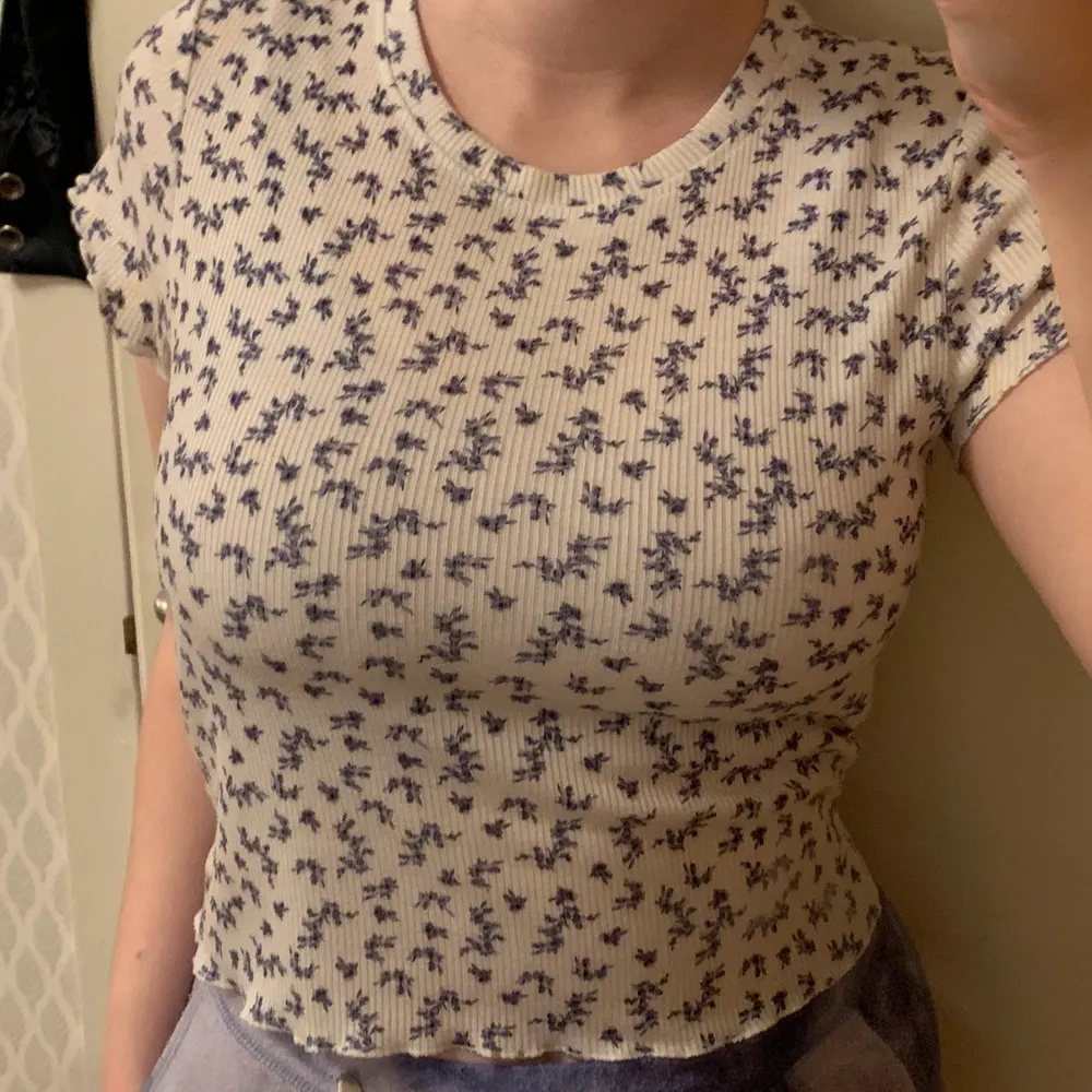 the cutest blue and white top from urban outfitters in size M, with tiny blue flowers and scalloped hems, perfect for spring and summer! 💙🤍. Toppar.