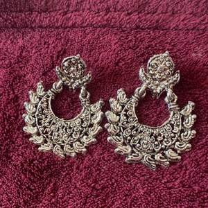 Silver colored stainless steel earrings from India.  Condition: New