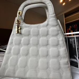 Väska  - Super snygg beige väska, handväska men även axelband medföljer. 