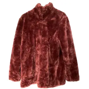 A wonderful wine red coat in faux fur. Bargain price!