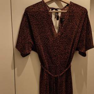 Perfect condition. Long dress with animal print. Opened back