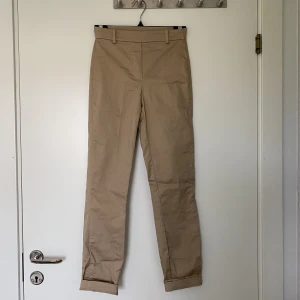 Beiga Kostymbyxor - Beiga kostymbyxor med resår i midjan. Skrynkliga på bilden. Ge gärna egna bud om pris inte passar. Är öppen för förslag!
