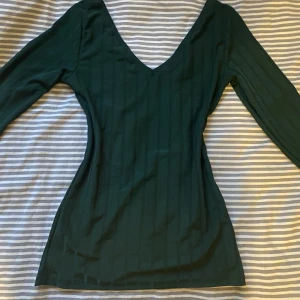 Långärmad tröja - Långärmad, mörkgrön tröja med typ ett ”shiny” material?
