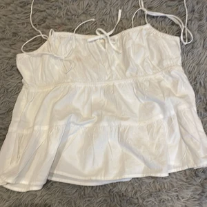 H&M topp - Säljer pga att den inte kommer till andvändning. Fint skick köpt för ungefär ett halvår sen men ändå bra skick har en liten fläck men den går nog bort med vanish medlet! Den är strl M men passar som en M-XXS eftersom att den är juseterbar! 🫶🏽💘