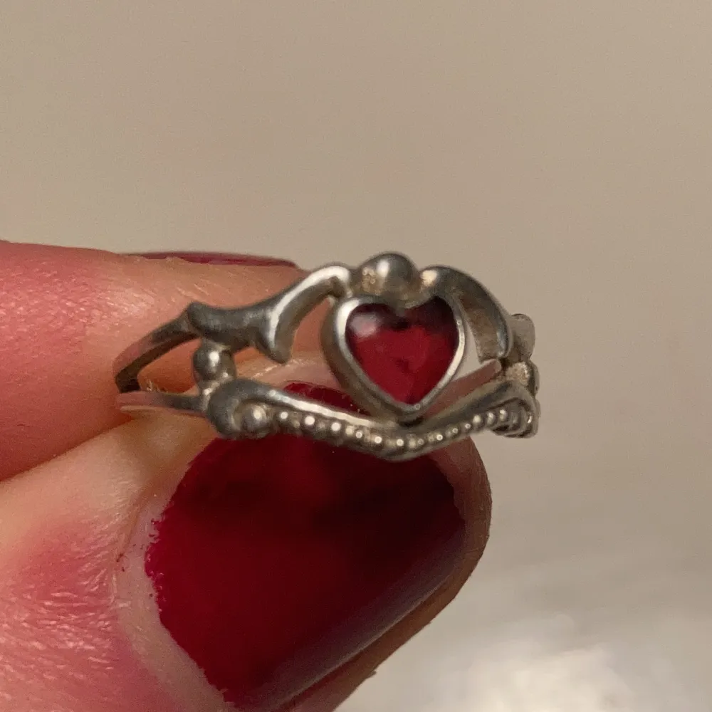 En super vacker ring med fin röd sten i form av ett hjärta i äkta silver (se sista bilden för stämpeln). ❤️. Accessoarer.