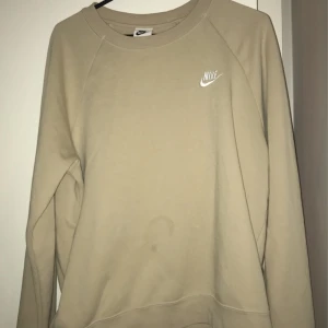 Nike tröja - Beige Nike sweatshirt. Det enda felet är fläcken på magen därav billigt pris.