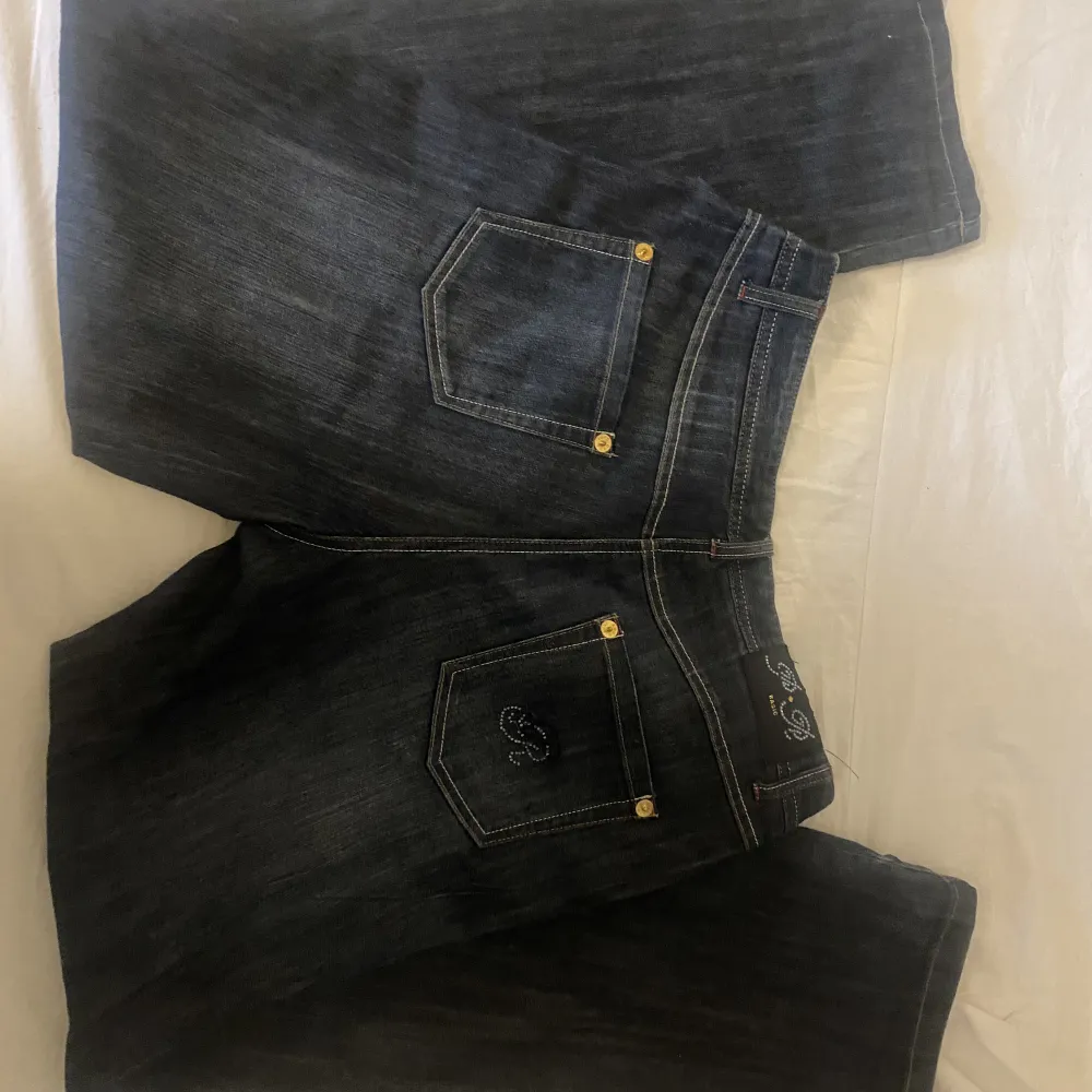 Baggy jeans mörkblåa med diamanter på fickan, lite rufsade på kanten längster på benen / pris kan diskuteras . Jeans & Byxor.