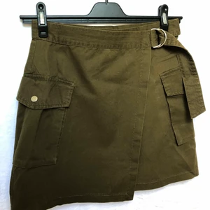 Olivgrön Cargo Kjol - Olivgrön Cargo kjol med fickor. Supersnygg till det mesta.