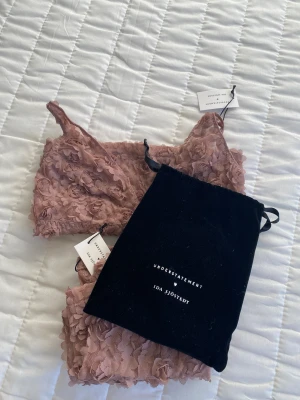 Vackert set Understatement <3 Ida Sjöstedt - Fint set från Understatements samarbete med Ida Sjöstedt. Helt oanvänt med lapparna kvar. En topp i storlek M och två par ”shorts” i storlek M och L. Härlig rosa färg (blush?) med vackert tyg. Ingår även en påse. Tror nypris var 500kr per del.