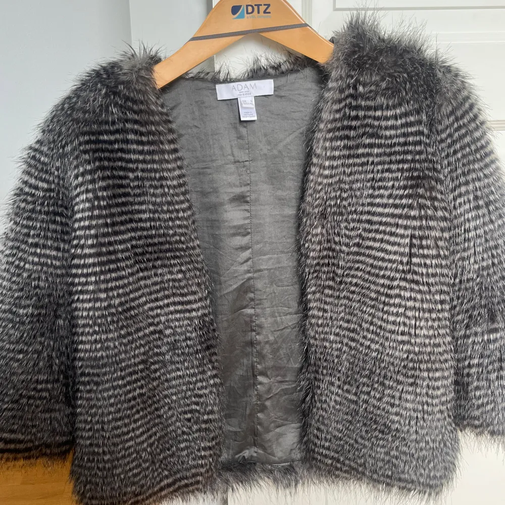 Säljer en superfin grå pälsjacka från NA-KD. Den är perfekt för att ge din outfit en lyxig touch. Jackan har ett randigt mönster och trekvartsärmar, vilket gör den både trendig och bekväm. Perfekt för höst och vinter!. Takit.