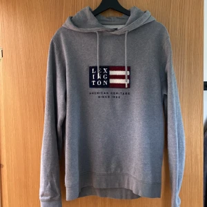 Lexington hoodie M - Jag säljer denna snygga Lexington hoodie som är i storlek M ocj har fint tryck på sig för jag inte längre kan ha den. Hoodien är i fin grå färg och bra material. Perfekt till hösten och funkar året om. Pris kan diskuteras vid snabb affär.