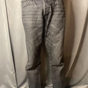 Grå jeans från Jack & Jones - Snygga grå jeans från Jack & Jones med klassisk femficksdesign. De har en rak passform och är tillverkade i slitstarkt denim. 