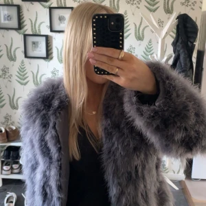 Pälsjacka  - Pälsjacka från Pello Bello i en grå lila färg, aldrig använd men köpt på Sellpy