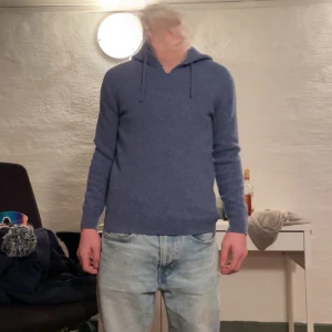 Blå Cashmere hoodie - Säljer en stilren blå hoodie, i storlek XS,  med långa ärmar och en praktisk huva. Perfekt för en avslappnad look. Den är mjuk och bekväm, idealisk för kyligare dagar. Köpte på plick, säljer igen pga för liten. 