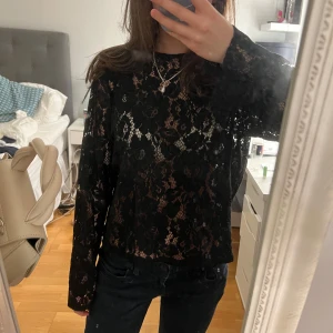Svart spetsblus med öppen rygg  - Snygg svart spetsblus med öppen rygg! ❣️använts en gång och är i mycket bra skicka! 