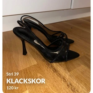 Svarta klackskor med remmar - Snygga svarta klackskor med smala remmar och spetsig tå. Perfekta för en elegant look. Klackarna är höga och ger en stilren siluett.
