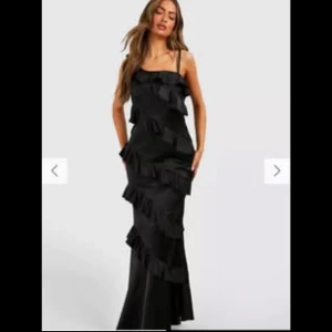 Svart långklänning från Boohoo - Elegant svart långklänning från Boohoo med volangdetaljer. Perfekt som balklänning/festklänning. Storlek 38🥰Helt ny! Superfint skick 
