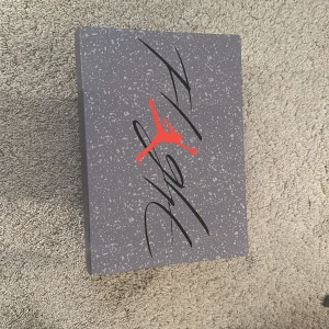 Nike Air Jordans 4 infrared - Säljer ett par Nike Air Jordans i grått och rött. Skorna är i nytt skick och har en snygg design med svarta och röda detaljer.Kommer i originalkartong.