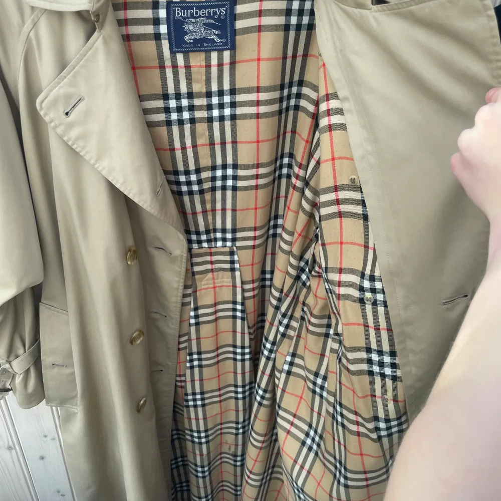 Burberry Women's Vintage Cream Beige Check Haymarket Trench Coat .                                   Säljer en klassisk beige trenchcoat från Burberry i mycket bra skick. Den har det ikoniska rutiga fodret och knappar framtill. Perfekt för höst och vår, med en tidlös stil som funkar till allt. Passar både till vardags och lite finare tillfällen. 🧥✨Ny pris på denna och burberry kappor i den här stilen ligger mellan 20-25 000kr. Jackor.