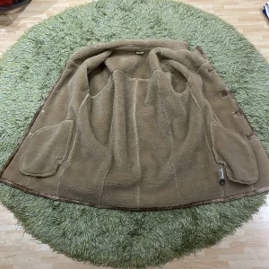 Brun mockajacka med teddyfoder - Säljer en snygg brun mockajacka med mjukt teddyfoder. Jackan har knappar framtill och praktiska fickor. Perfekt för höst och vinter, håller dig varm och stilren. Passar både till vardags och lite finare tillfällen. 🧥✨