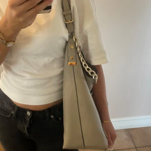Väska från river island - Handväska från river island. Fin väska i gott skick med mycket plats. Fickor inuti samt ett extra band om man föredrar det🤍